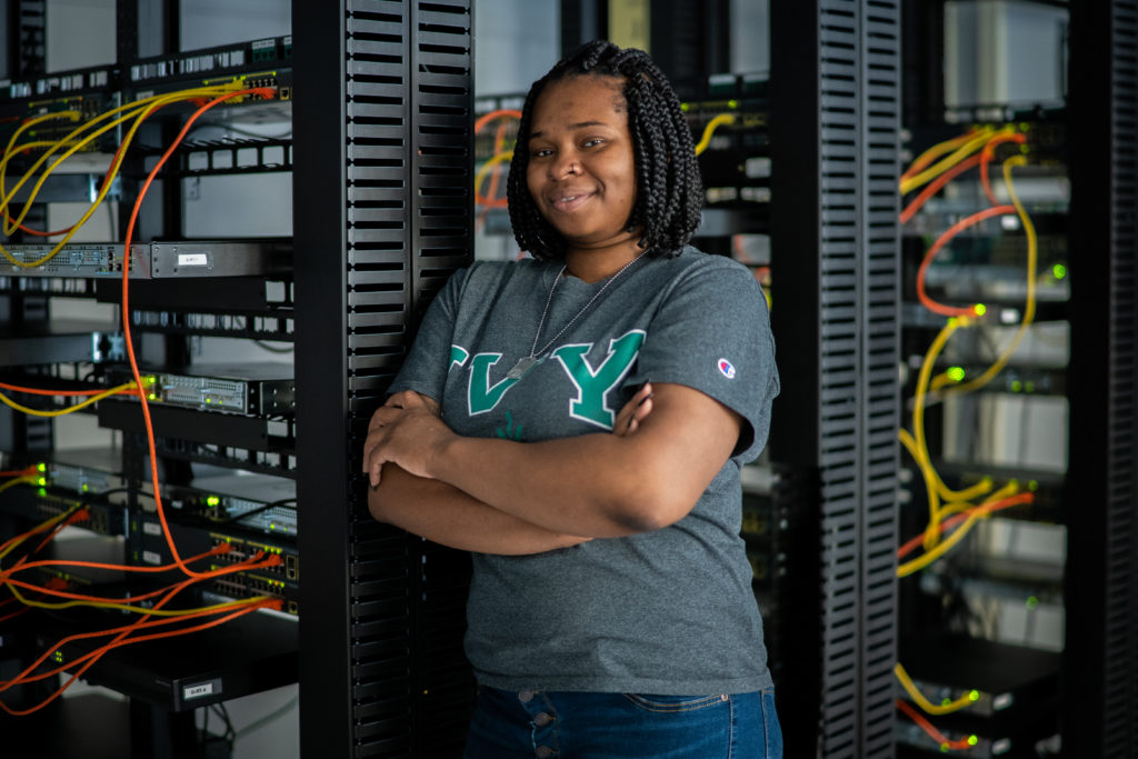 Student posing in a server room